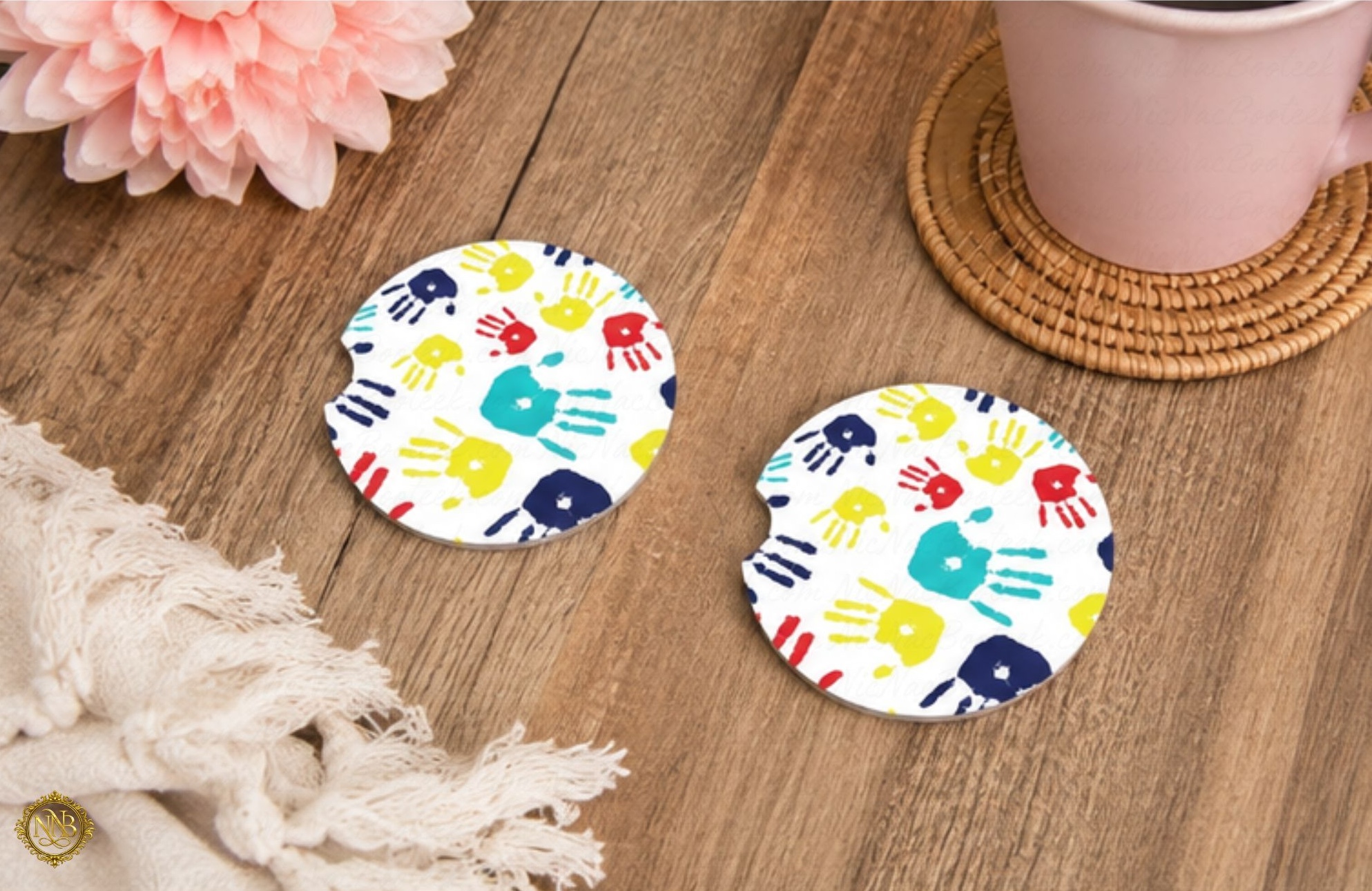 Colorful Autism Awareness ceramic car coasters with playful children’s handprint artwork displayed in cozy lifestyle setting.