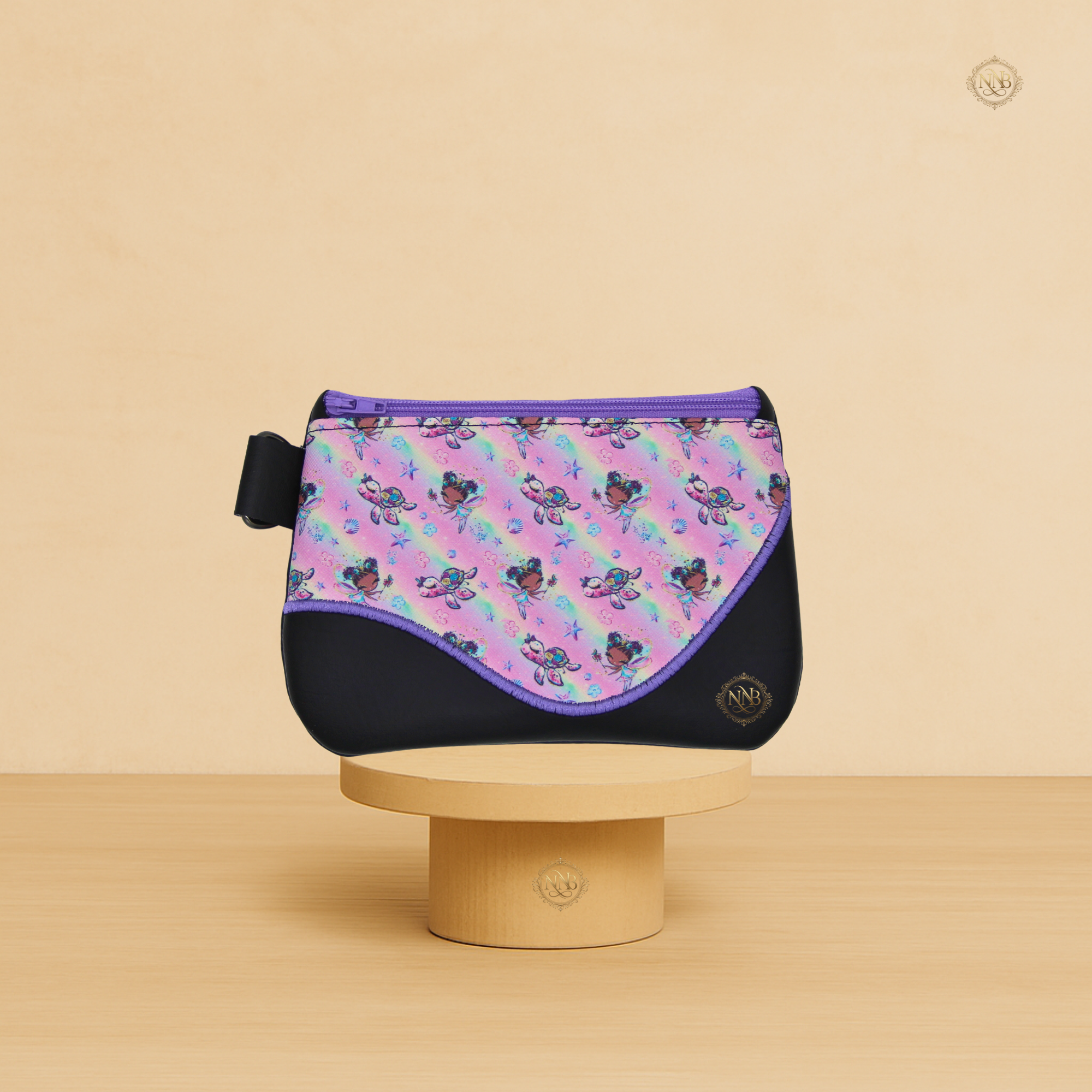 Handmade fairy princess vinyl zip pouch with illustrated fabric panel and purple zipper on a display stand