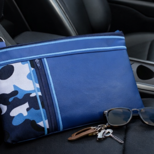 blue camo zip pouch with faux leather panel and zipper closure shown in lifestyle and flat lay