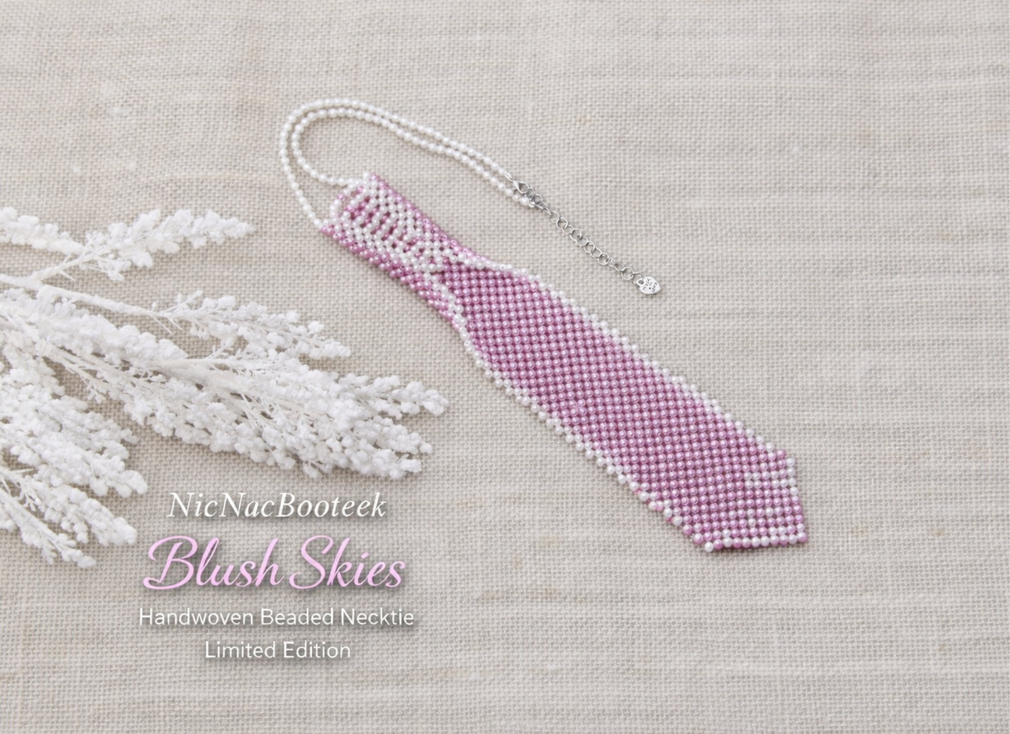 Handwoven beaded necktie in Blush Skies with lavender and white beads on neutral linen background