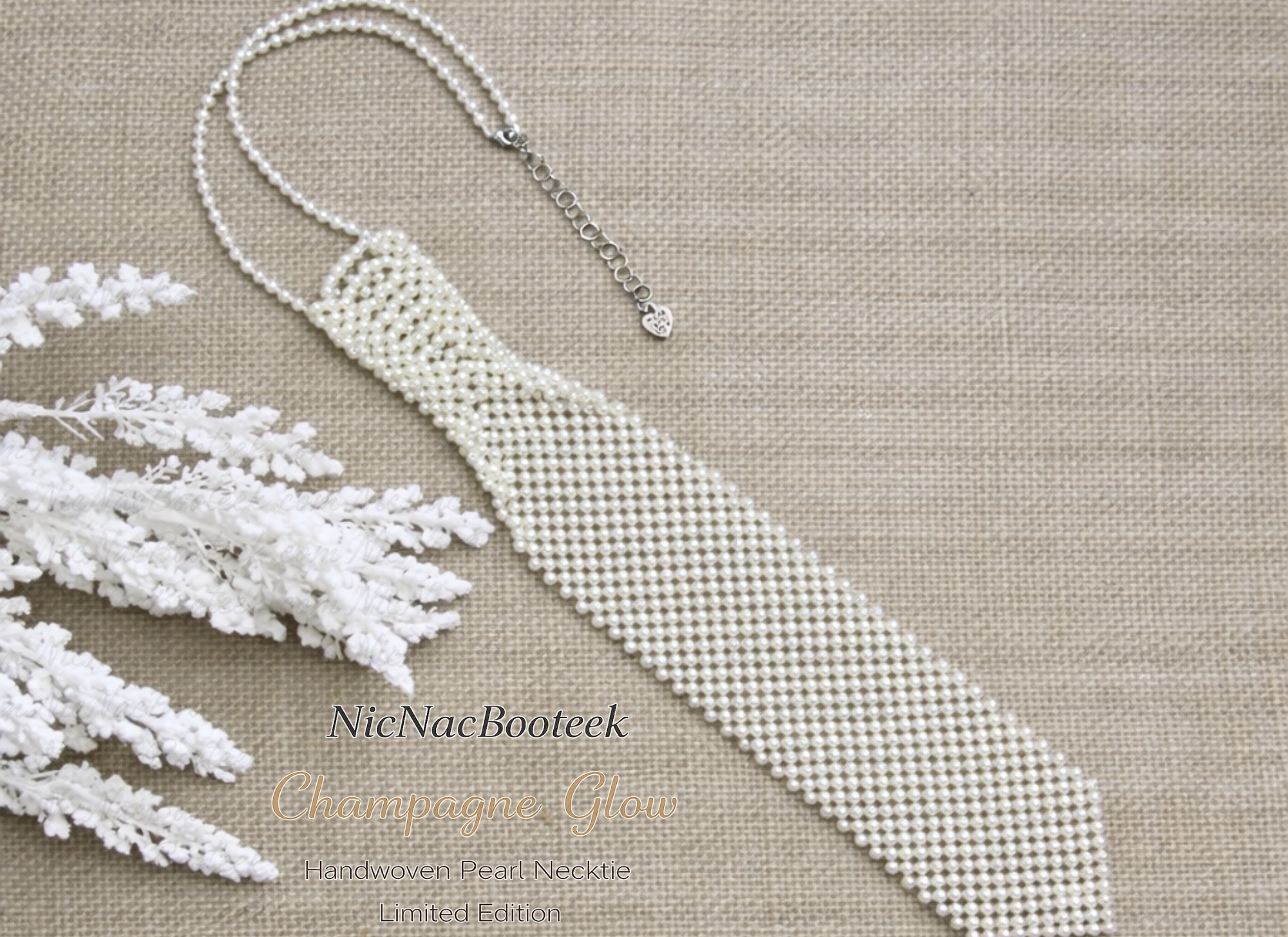 Handwoven pearl beaded necktie in Champagne Glow on neutral linen background