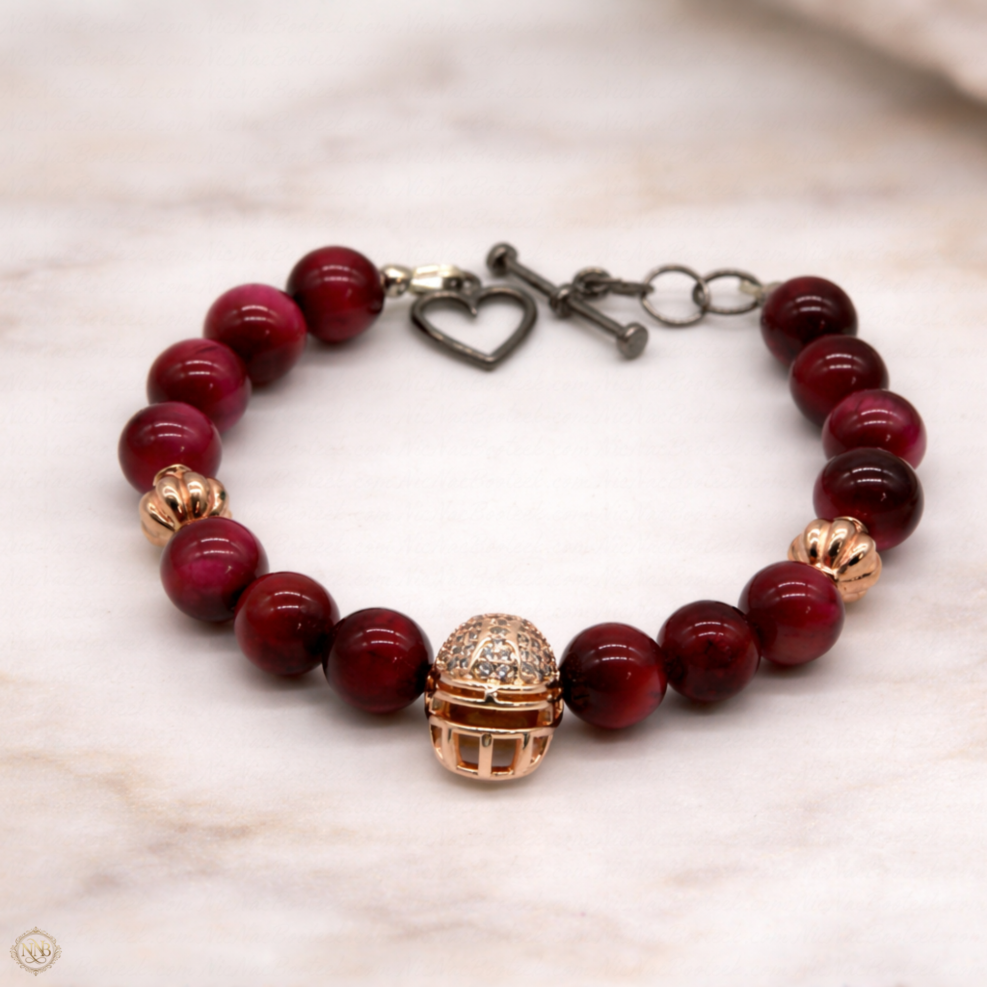 Rose Ascension 8mm rose-stone bracelet with gold accents and toggle clasp on neutral background.
