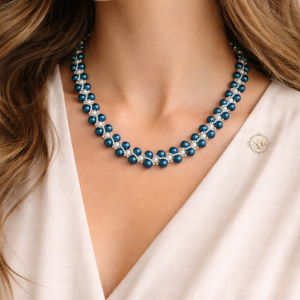 Handcrafted blue and white beaded necklace with a woven pattern and magnetic clasp, measuring approximately 21 inches in length on a clean background.