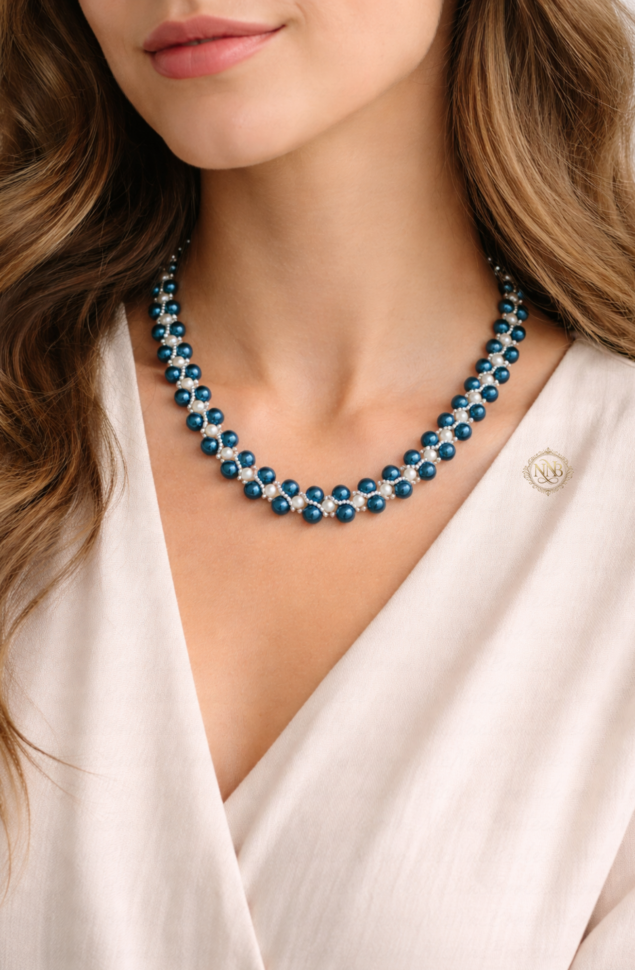 Handcrafted blue and white beaded necklace with a woven pattern and magnetic clasp, measuring approximately 21 inches in length on a clean background.