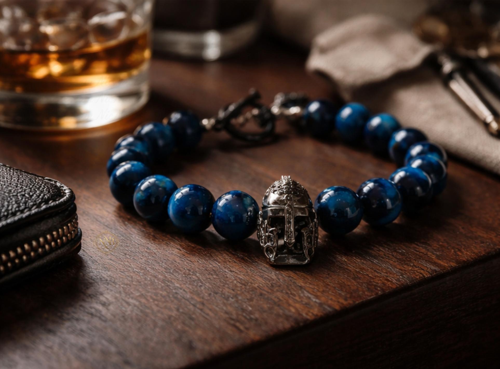 Detail view of tiger's eye gemstone bracelet featuring gunmetal warrior helmet charm.