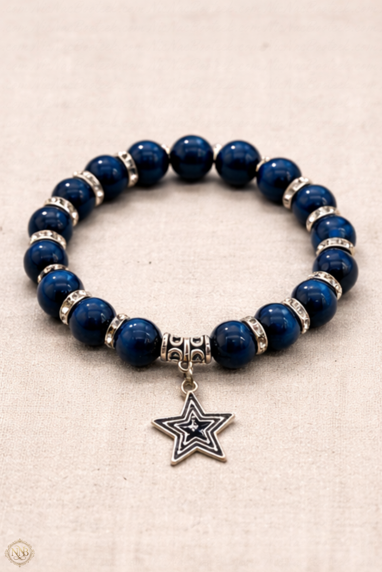 Blue Tiger’s Eye 12mm unisex stretch bracelet with silver rhinestone spacers and silver star charm on neutral background.