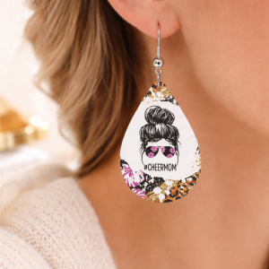 Woman wearing luxury cheer mom teardrop earrings with bold graphic design and silver hook hardware