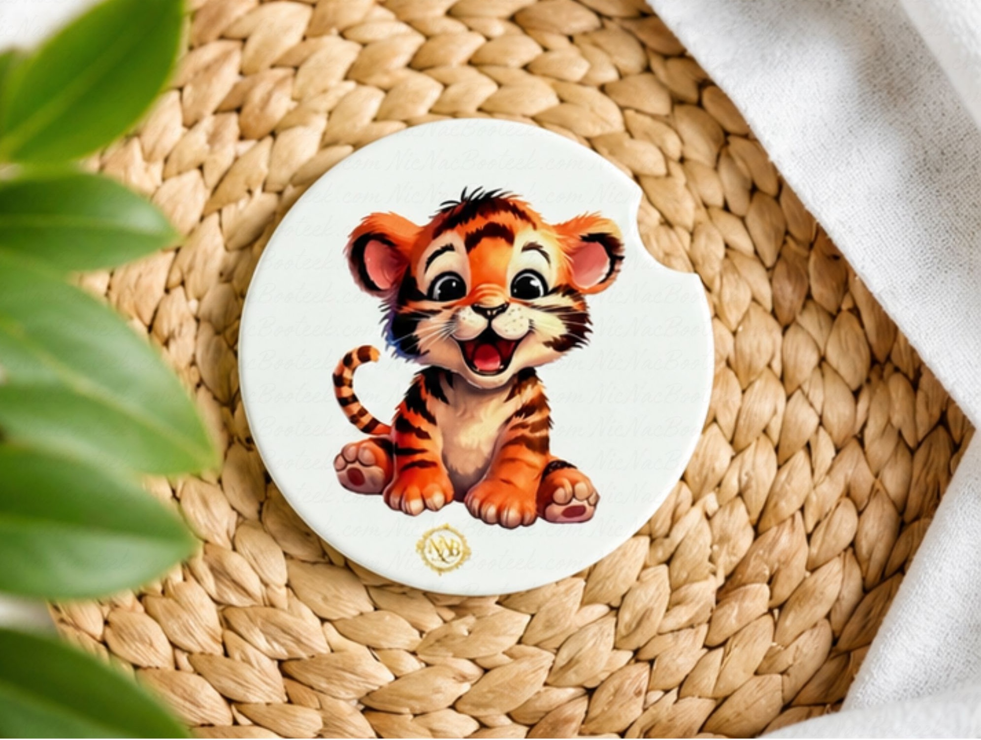 Tiny Tiger ceramic car coaster displayed on a woven natural texture surface with soft greenery and modern boutique NicNacBooteek styling.