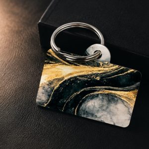 Close-up lifestyle image of the Obsidian Luxe Dog Tag featuring deep black abstract movement, flowing gold accents, and elevated boutique fashion styling by NicNacBooteek.