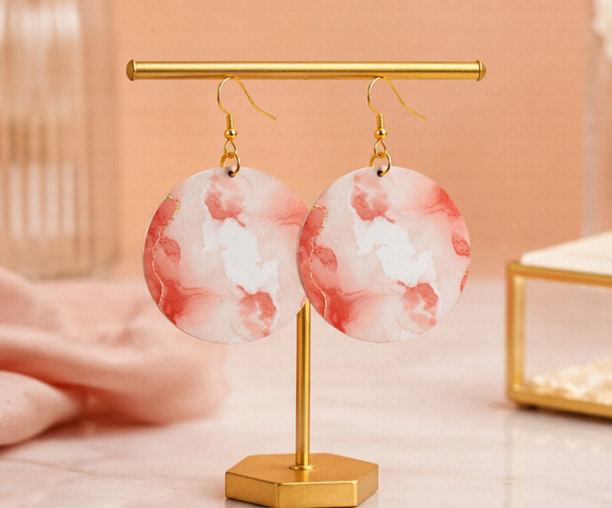 Rose Mist Statement Earrings hanging on a modern gold jewelry stand featuring soft rose artwork and elevated boutique styling by NicNacBooteek.