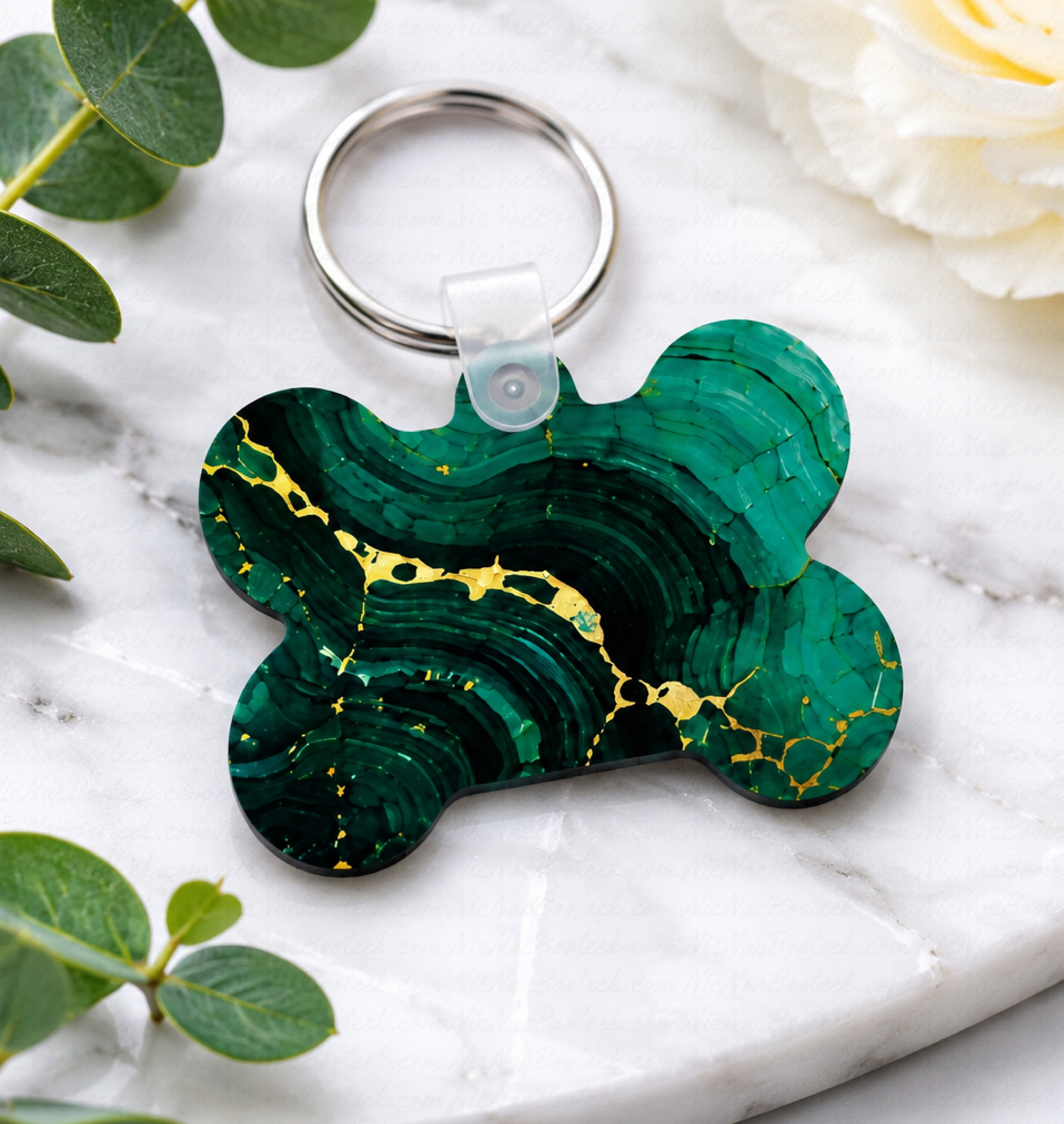 Emerald marble luxury bone-shaped pet ID tag with gold veining and silver key ring on a white background.
